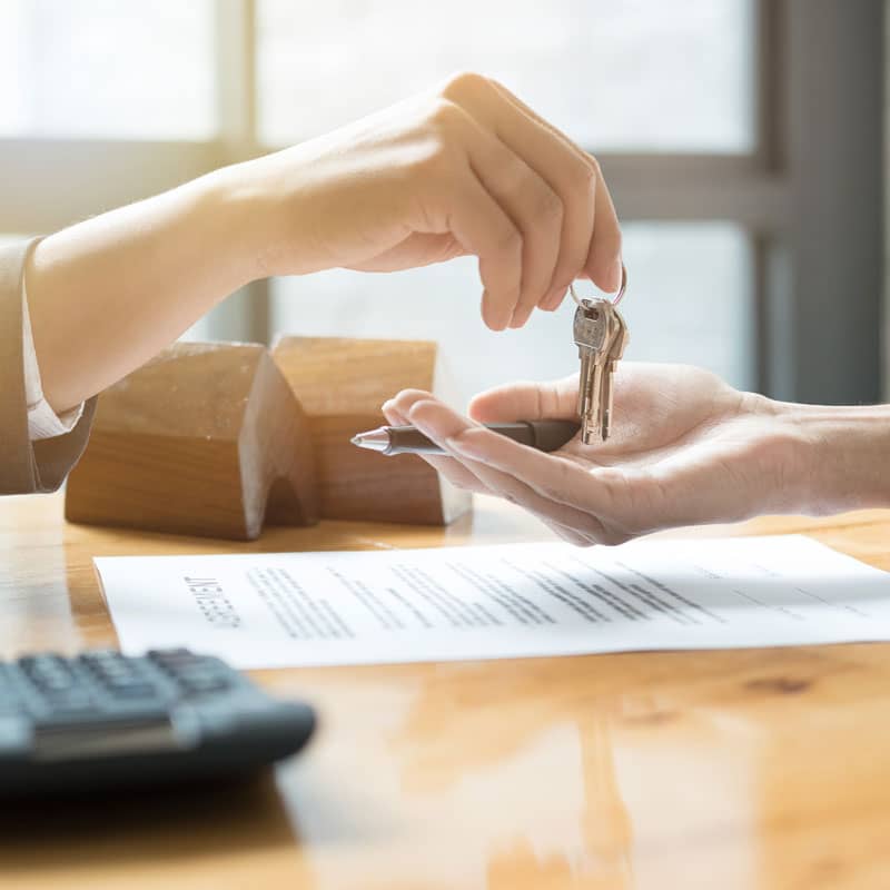 Estate agent handing keys to tenant